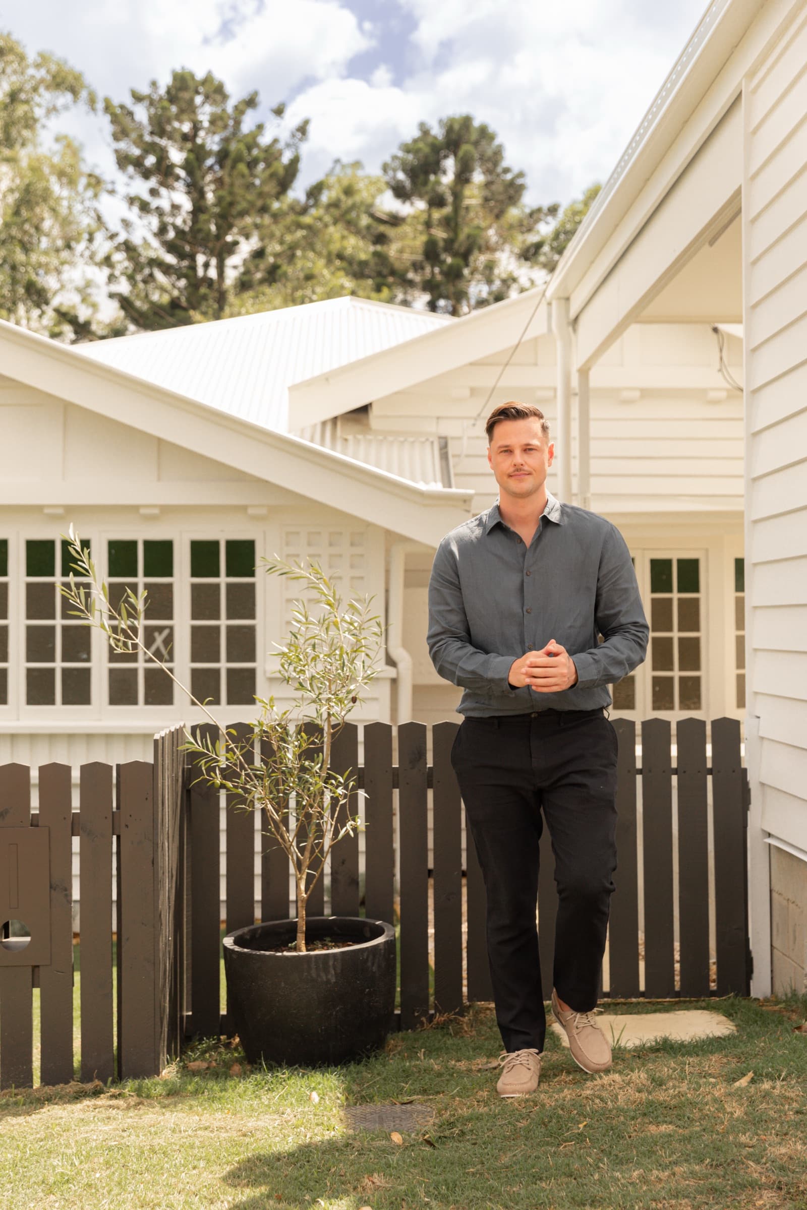 Jack Freestone of Buyers Collective outside a white Queenslander home in Brisbane