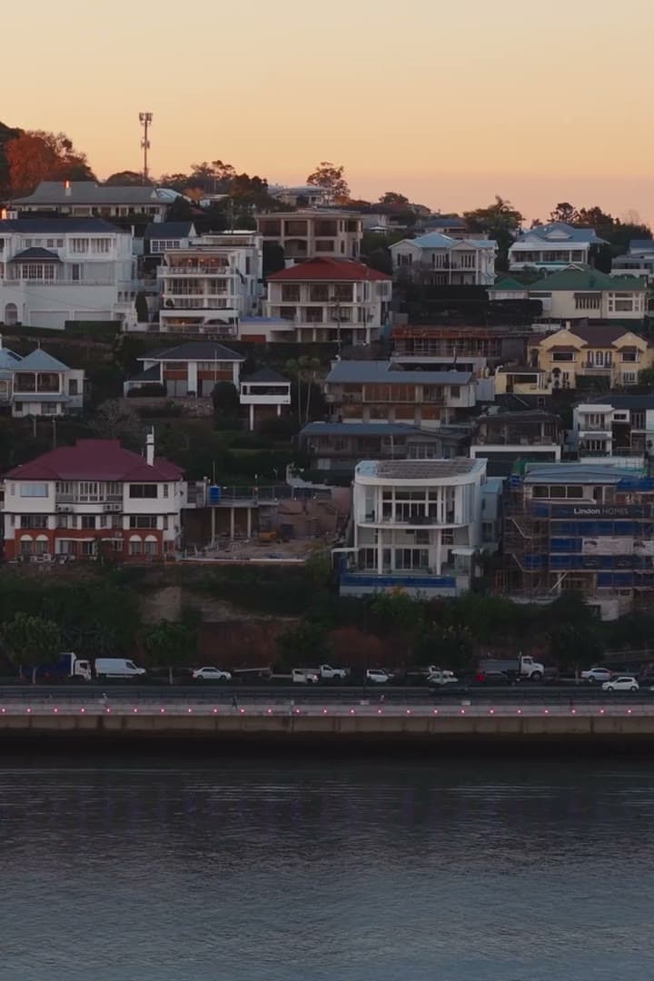 Homes on the Hamilton hillside above Kingsford Smith Drive at dusk